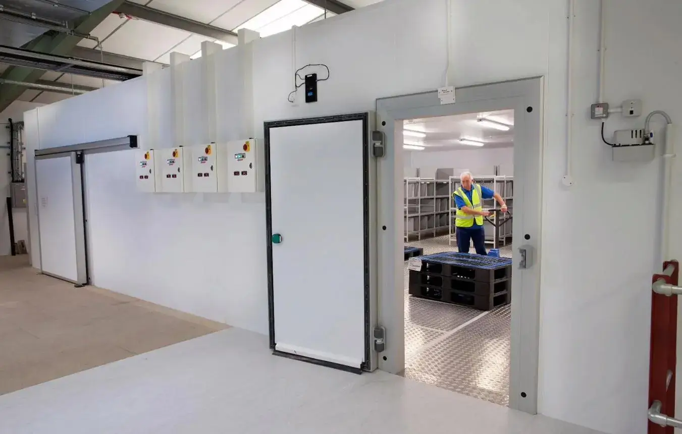 Cold room contractors fitting high-density PIR insulation panels in a walk-in cold room
